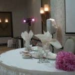 Sweetheart table with DJ booth in background